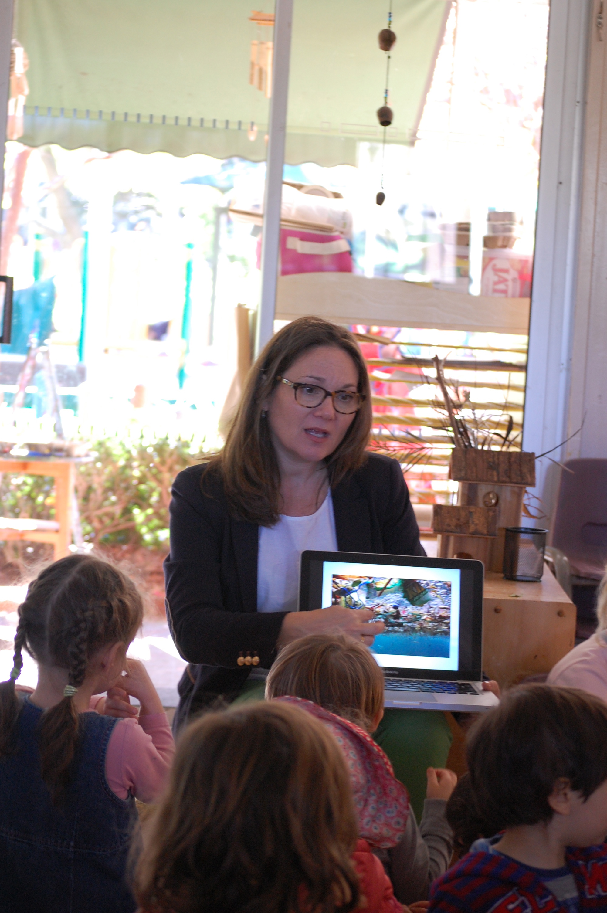 Discussing ocean pollution with a group of Pre-K students